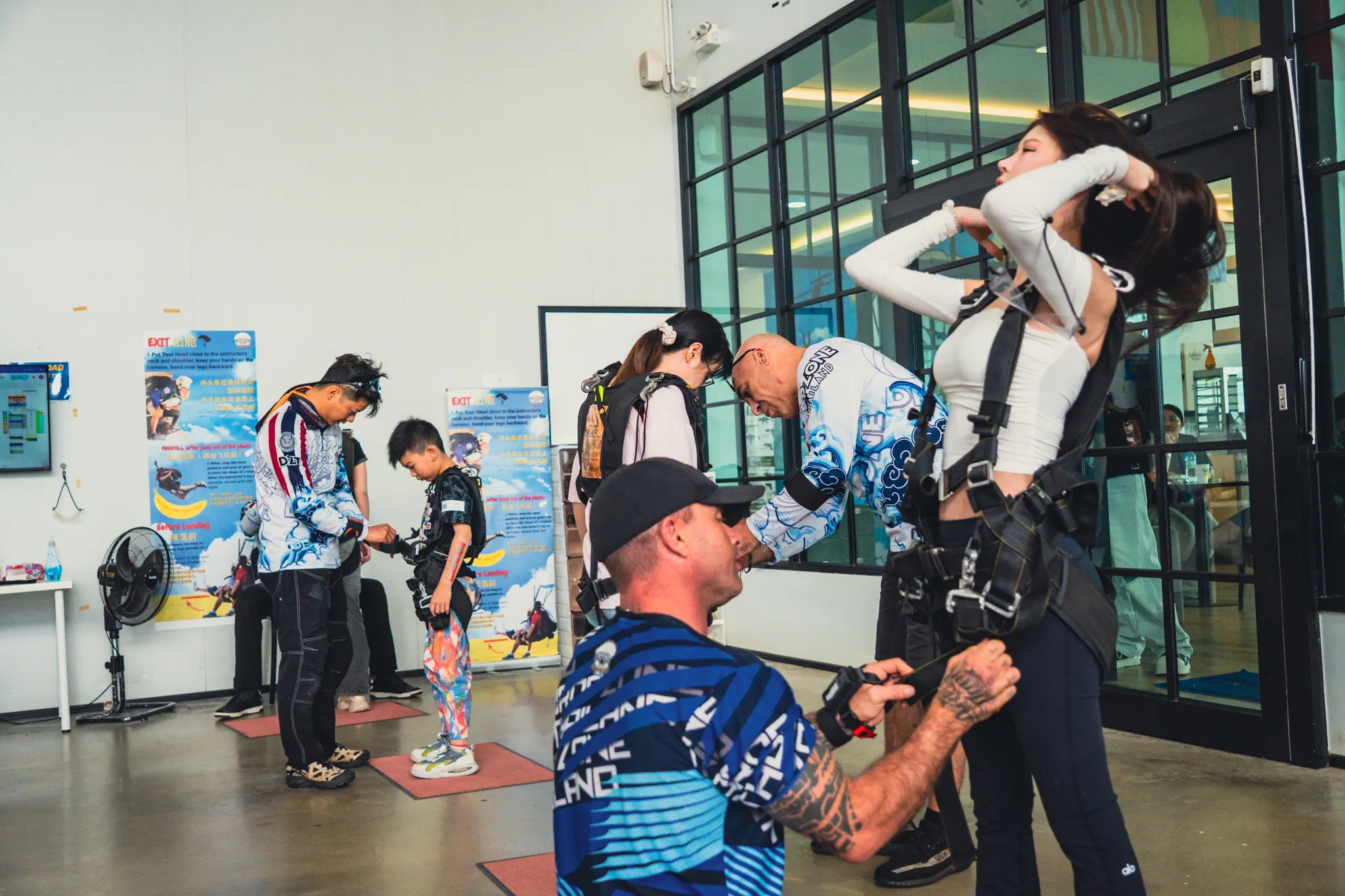 Instructor helping a tandem customer with her harness at the Pattaya dropzone
