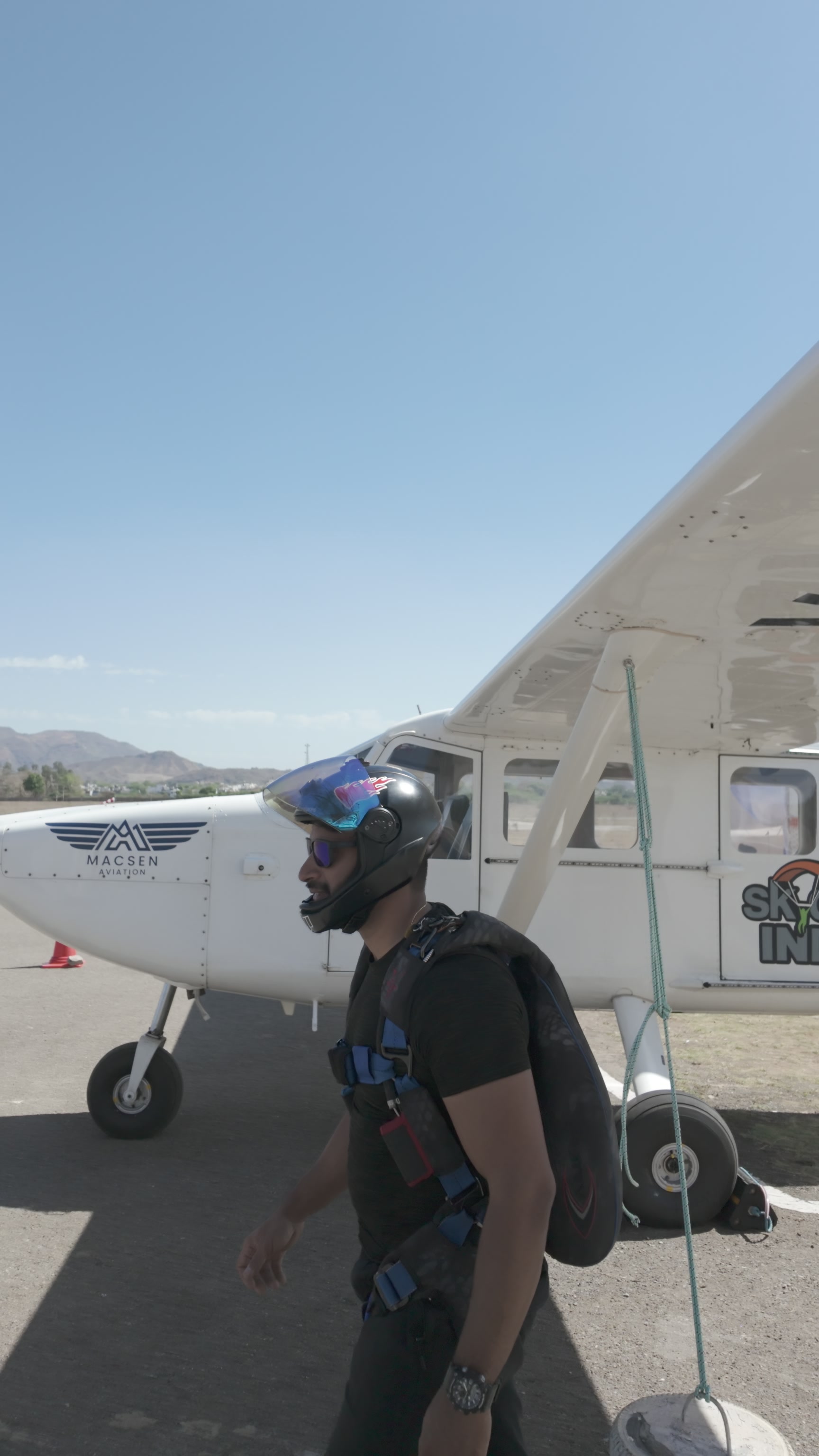 Anubhav in full skydiving gear beside the aircraft at Mount Abu
