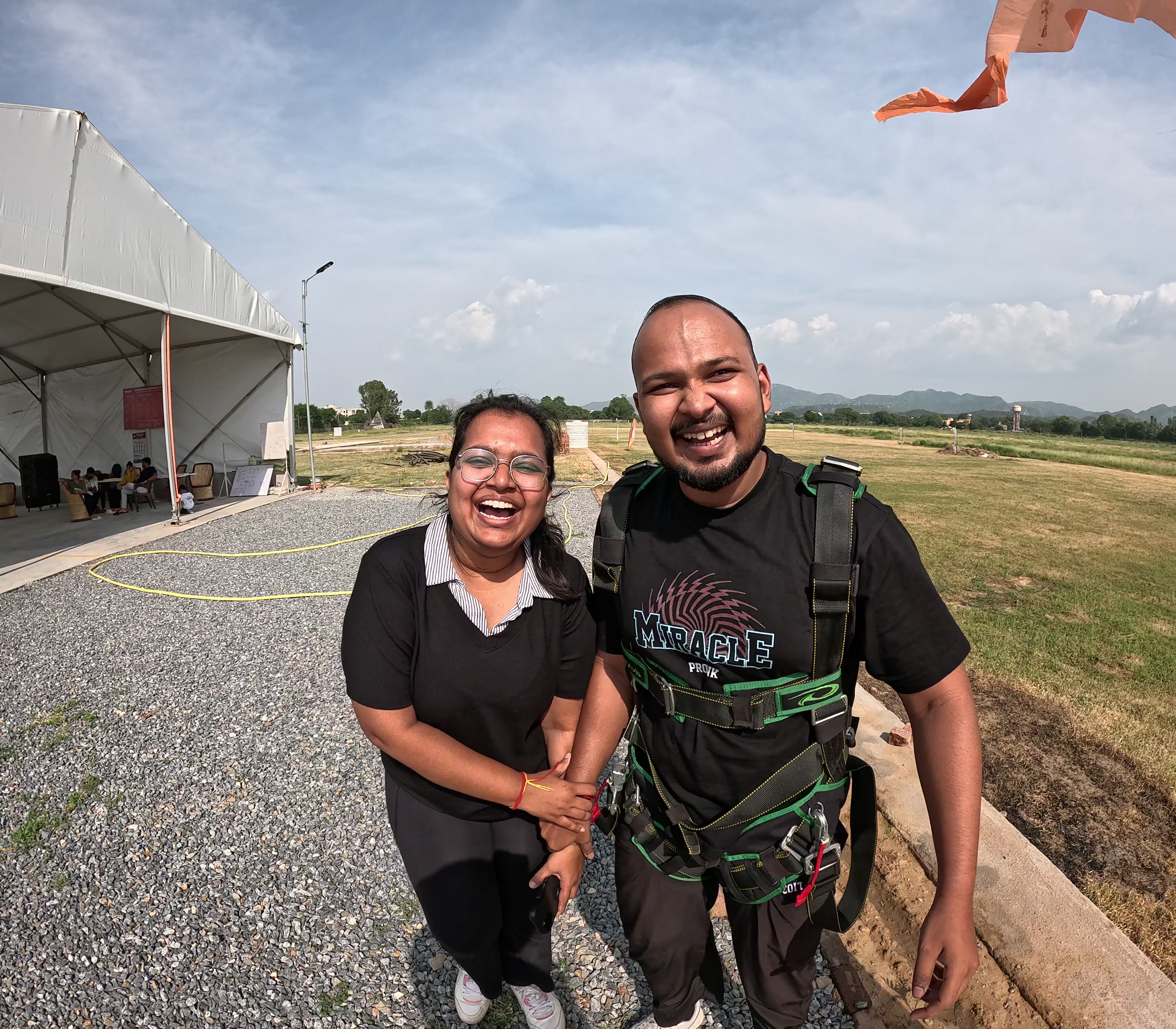 Smiling tandem customer wearing a harness at the Mount Abu dropzone