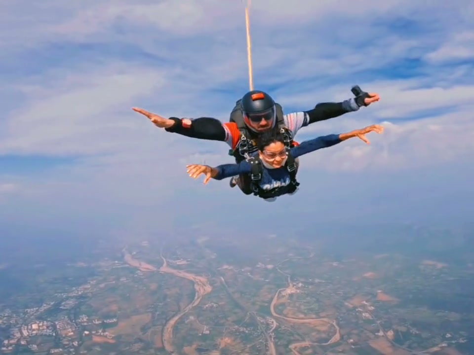 Tandem skydiver in freefall above Mount Abu