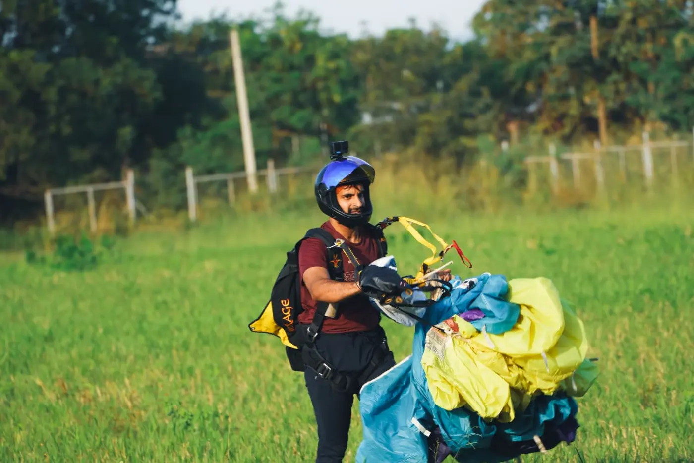 Tandem instructor gathering the parachute after landing at the Pattaya dropzone