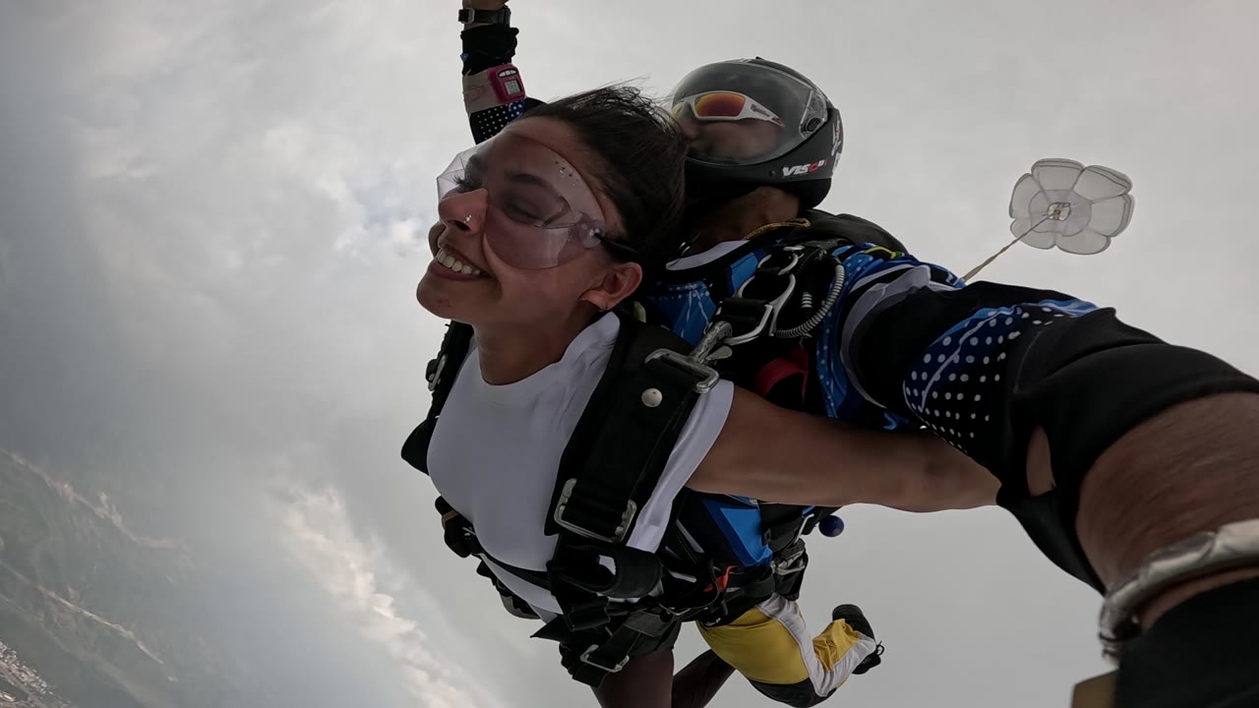 Close view of a tandem passenger smiling during freefall