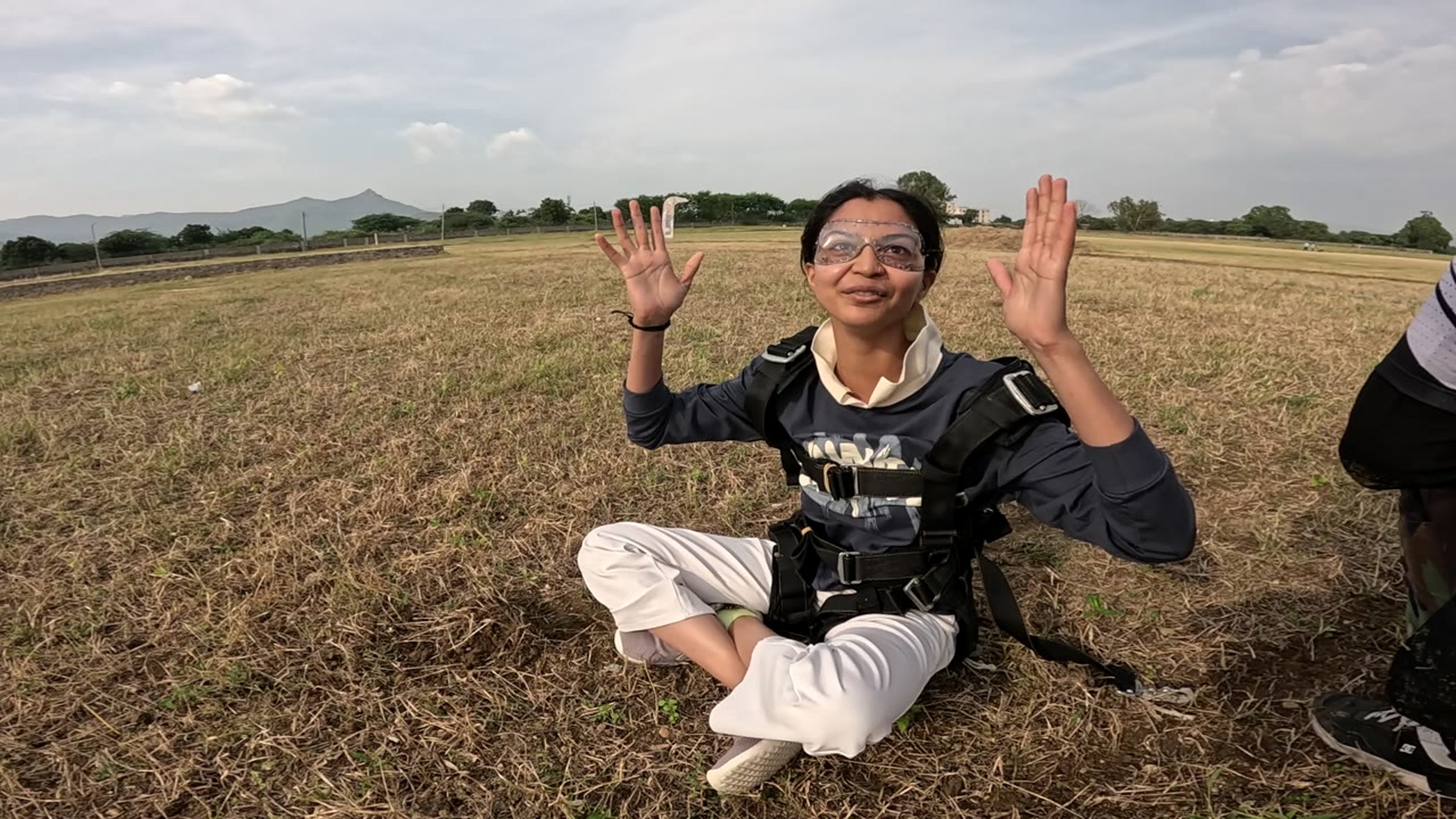 Tandem passenger celebrating after landing at the Mount Abu dropzone